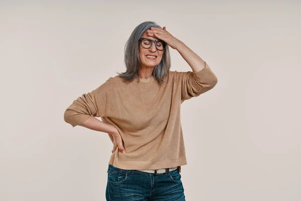 Frustrated mature woman suffering from headache and touching her forehead — Stock Photo, Image