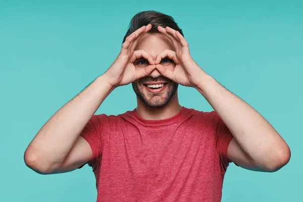 Portrait of handsome young man in casual wear gesturing and smiling — Stock Photo, Image