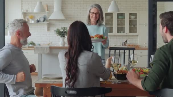 Happy multi-generation family smiling while having dinner together — Stock Video