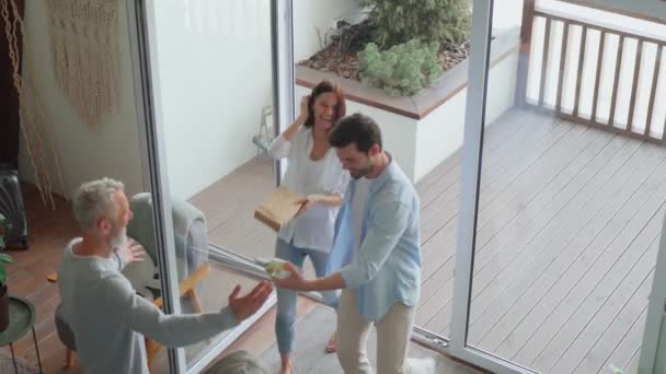 Top view of happy senior parents meeting young couple inside the house — Stock Video