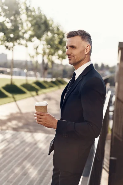 Confident Mature Businessman Holding Coffee Cup While Standing Outdoors — Stock Photo, Image