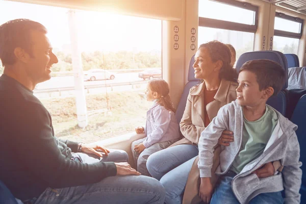 Family with two little kids enjoying train journey together — Stock Photo, Image