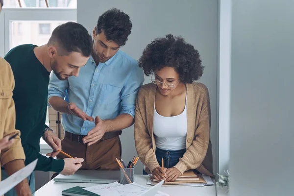 Confident business team having quick meeting while standing near office desk together — Stock Photo, Image