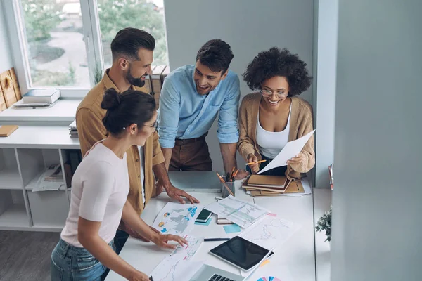 Blick von oben auf ein selbstbewusstes junges Business-Team, das sich schnell trifft, während man gemeinsam im Büro steht — Stockfoto