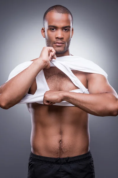 African man taking off his tank top — Stock Photo, Image