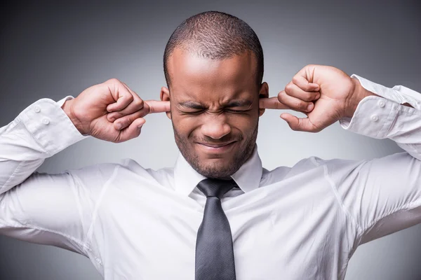 African man in shirt and tie covering ears — Stock Photo, Image