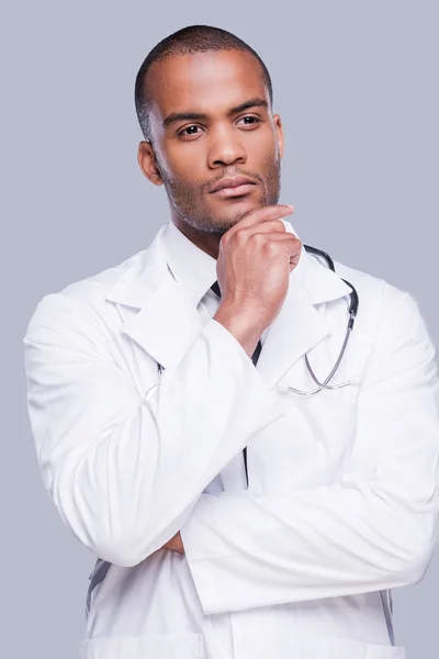 African doctor holding hand on chin — Stock Photo, Image