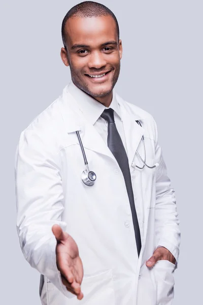 African doctor stretching out hand for shaking — Stock Photo, Image