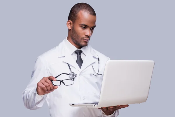 African doctor holding laptop — Stock Photo, Image