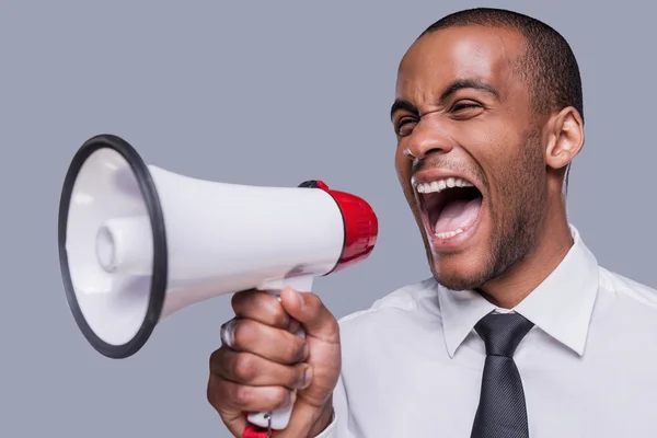 Africano em formalwear gritando em megafone — Fotografia de Stock