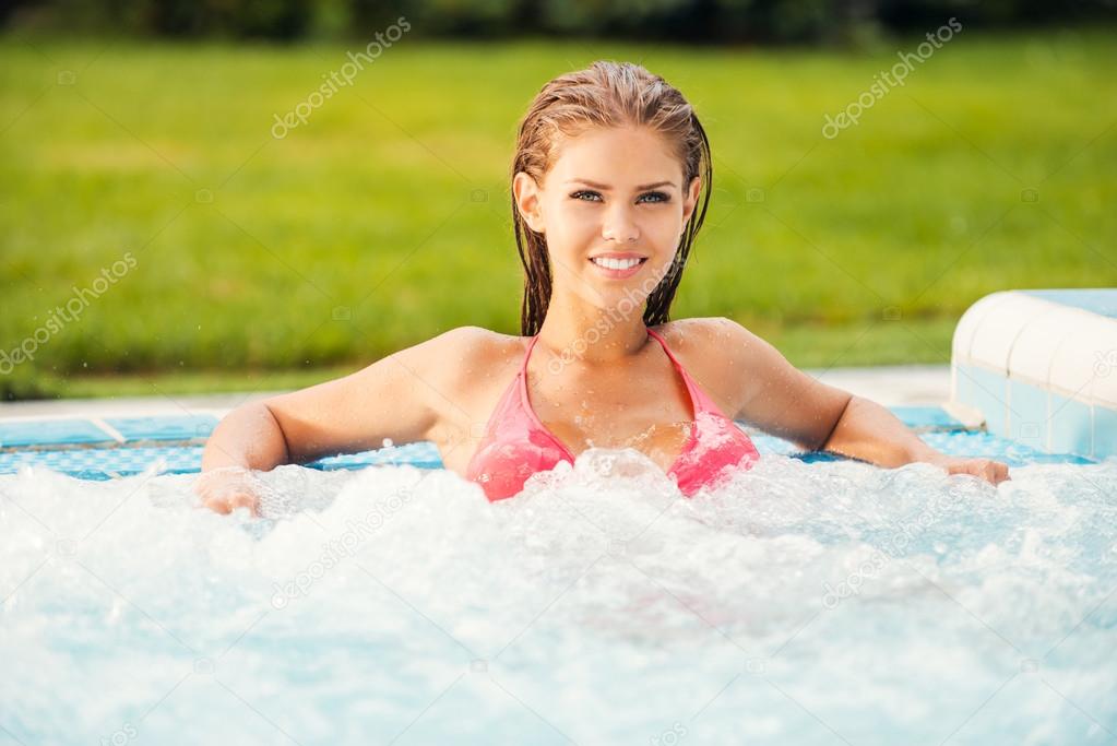 Woman in bikini relaxing in hot tub