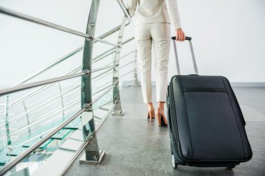 Businesswoman carrying suitcase clipart