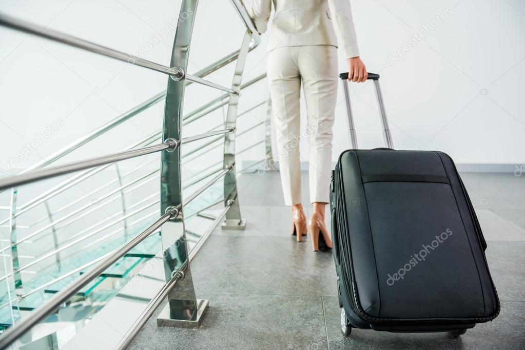 Businesswoman carrying suitcase