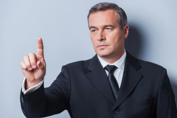 Mature man in formalwear touching virtual board — Stock Photo, Image