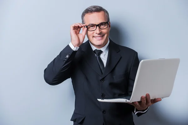 Mature man in formalwear adjusting eyeglasses — Stock Photo, Image