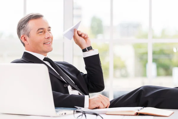 Mature man in formalwear holding paper airplane — Stock Photo, Image