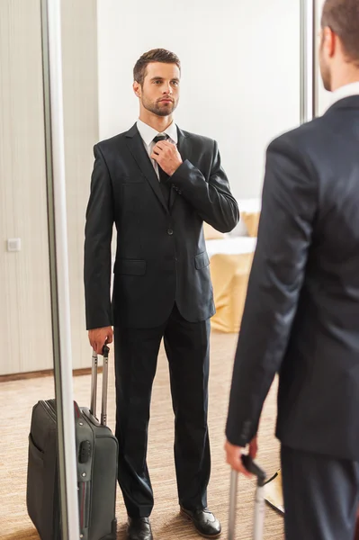 Man in formalwear adjusting his necktie — Stock Photo, Image