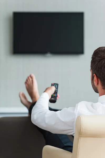 Man in white shirt watching TV — Stock Photo, Image