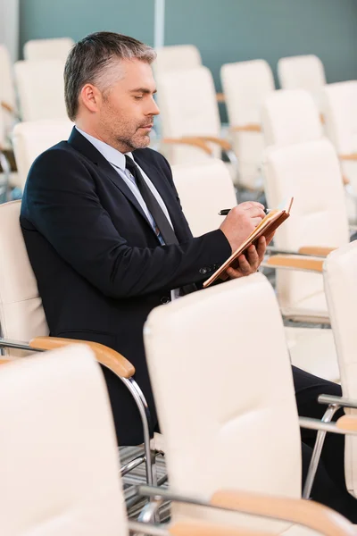 Mature man in formalwear in empty conference hall — Stock Photo, Image