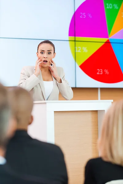 Woman in formalwear standing at the tribune — Stock Photo, Image