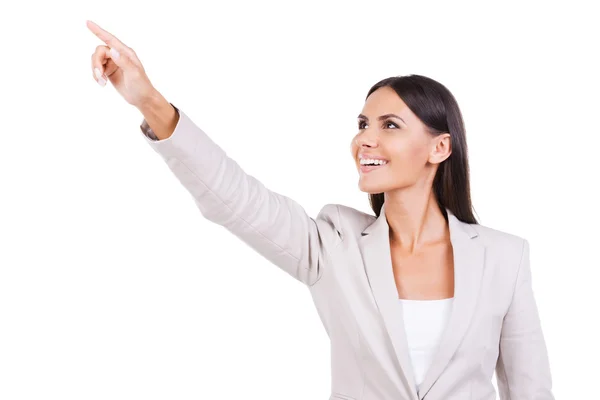 Businesswoman in suit pointing away — Stock Photo, Image