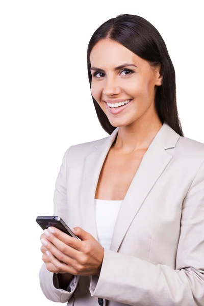 Businesswoman in suit holding mobile phone — Stock Photo, Image