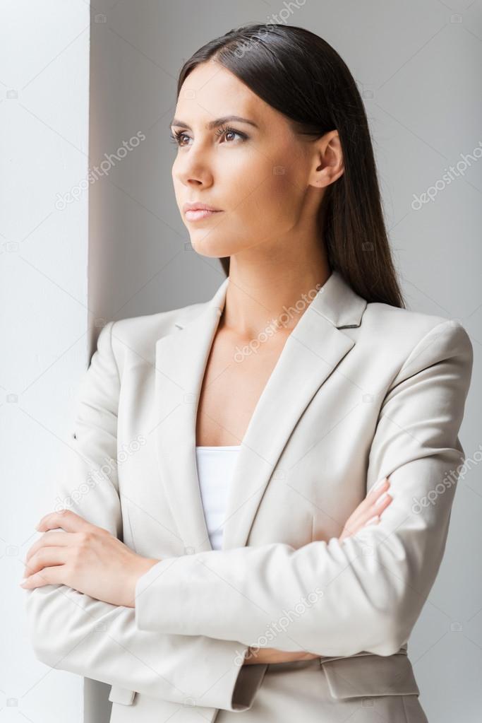 Businesswoman keeping arms crossed