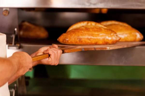 Man taking fresh bread — Stock Photo, Image