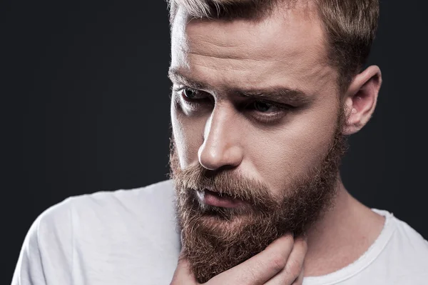 Thoughtful young bearded man — Stock Photo, Image