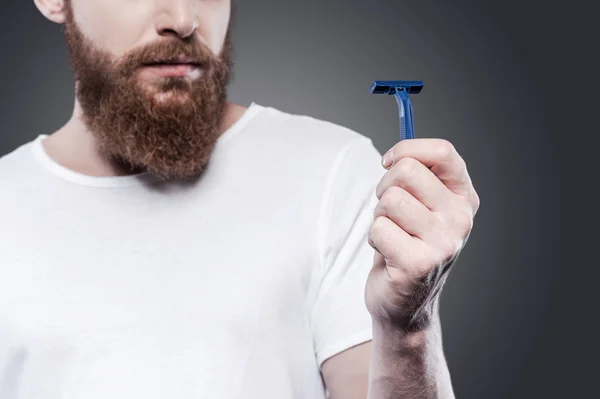 Bearded man holding razor — Stock Photo, Image