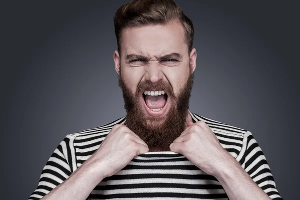 Bearded man in striped clothing stretching his collar
