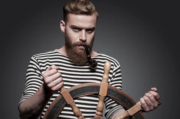 Bearded sailor steering a wheel — Stock Photo, Image