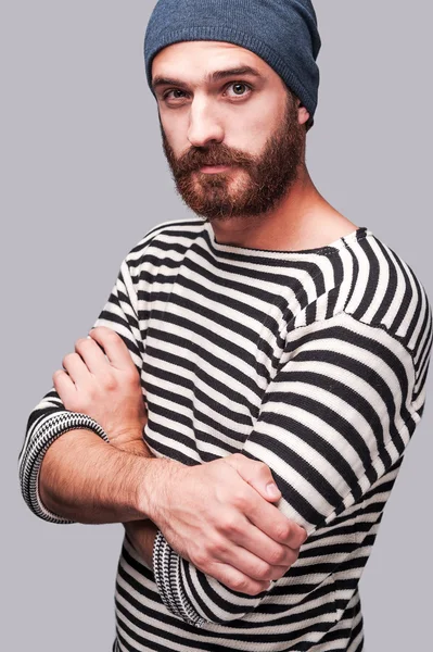 Bearded man in striped clothing keeping arms crossed — Stock Photo, Image