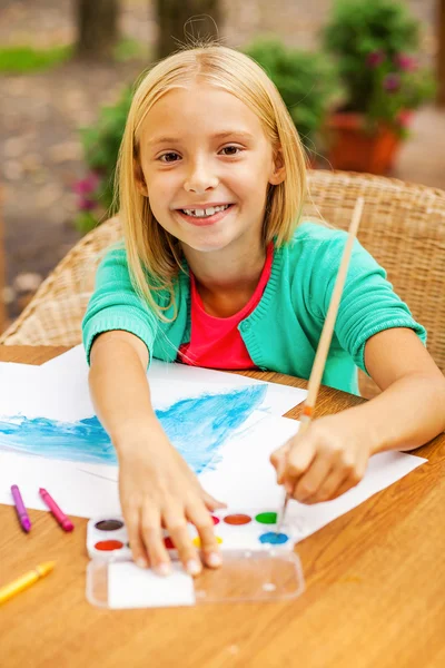 Little girl drawing something on paper — Stock Photo, Image