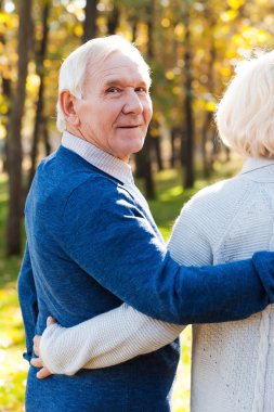 Park eşi ile yürüyen mutlu üst düzey adam