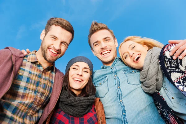 Quatre jeunes gens heureux se lient entre eux — Photo