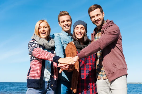 Young people holding hands together — Stock Photo, Image