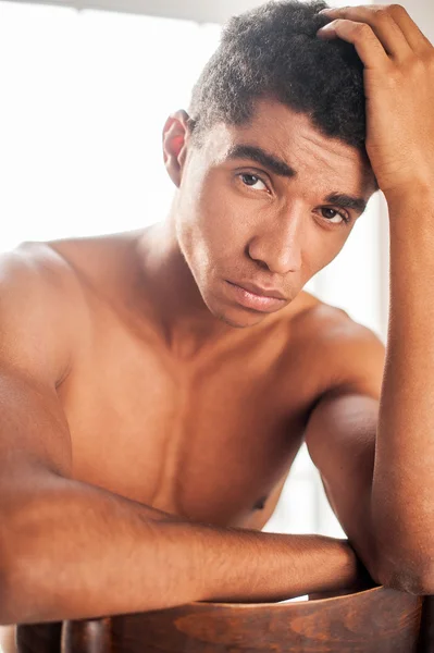 Young Afro-American man sitting on the chair — Stock Photo, Image