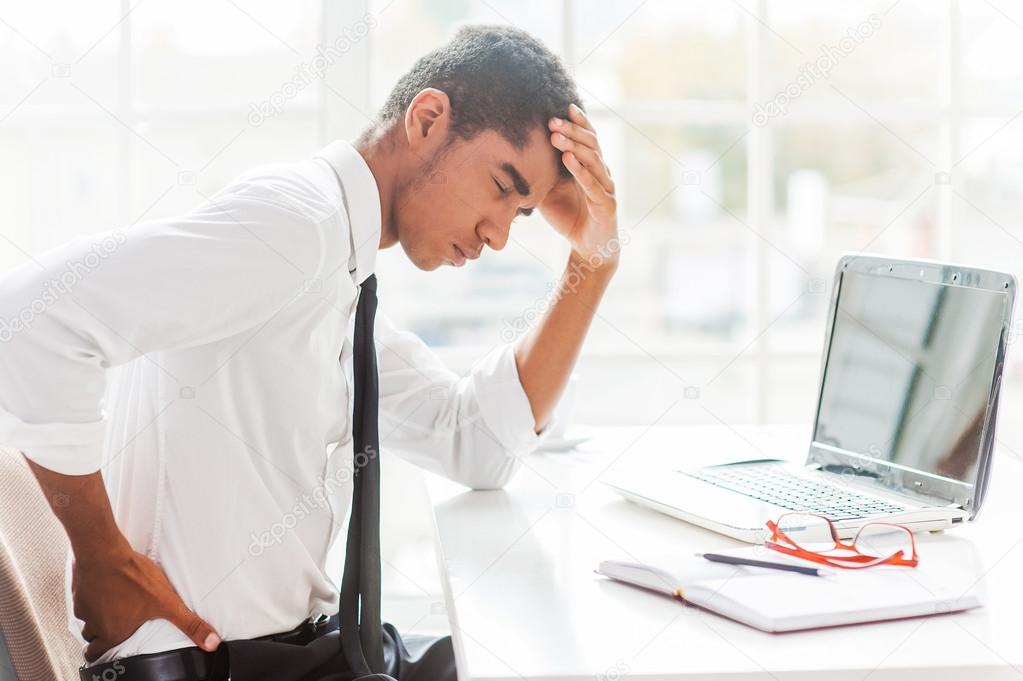 Afro-American man  sitting at his work place