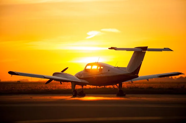 Airplane in airport with sunset — Stock Photo, Image