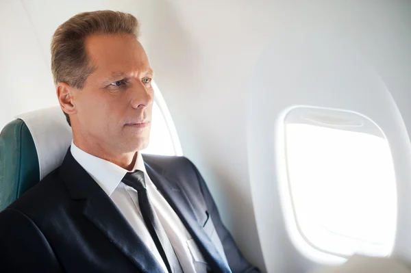 Businessman sitting at his seat in airplane — Stock Photo, Image