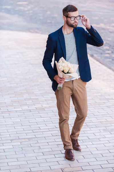 Handsome young man holding bouquet of flowers — Stock Photo, Image