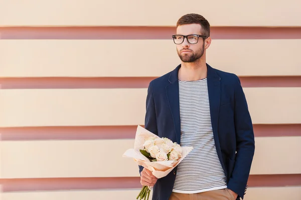 Man in smart jacket holding bouquet of flowers — Stock Photo, Image