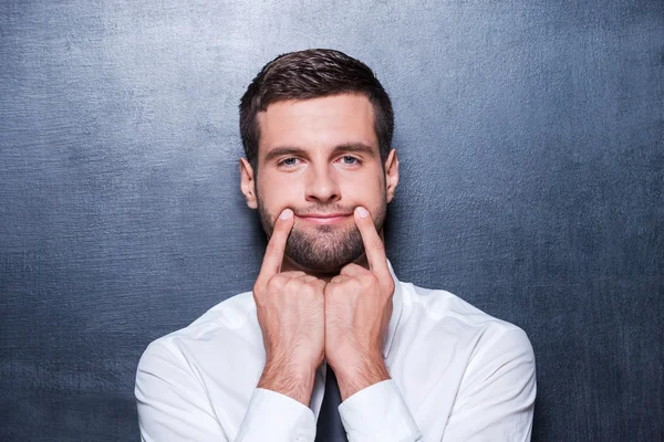 Man holding fingers on mouth — Stock Photo, Image