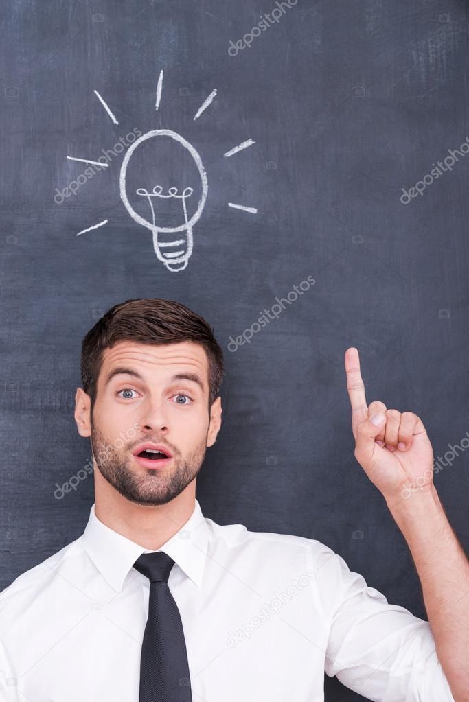 Young man with chalk drawing of light bulb