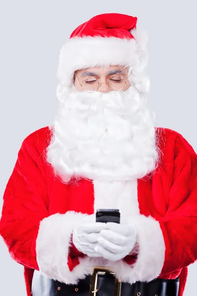 Santa Claus holding mobile phone — Stock Photo, Image