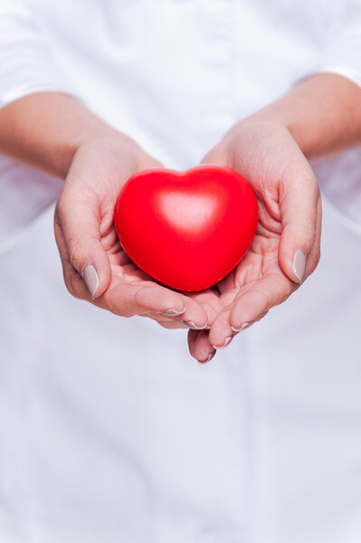 Female doctor holding heart prop