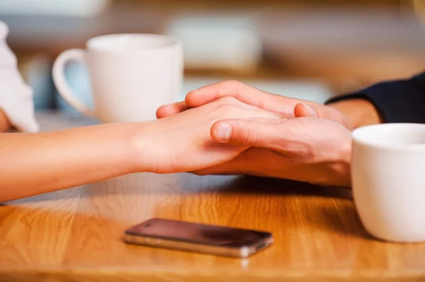 Couple holding hands  in cafe — Stock Photo, Image
