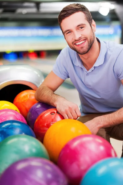 Muž sedící poblíž bowlingové koule — Stock fotografie