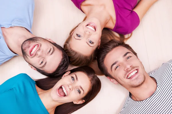 Cheerful friends lying down — Stock Photo, Image